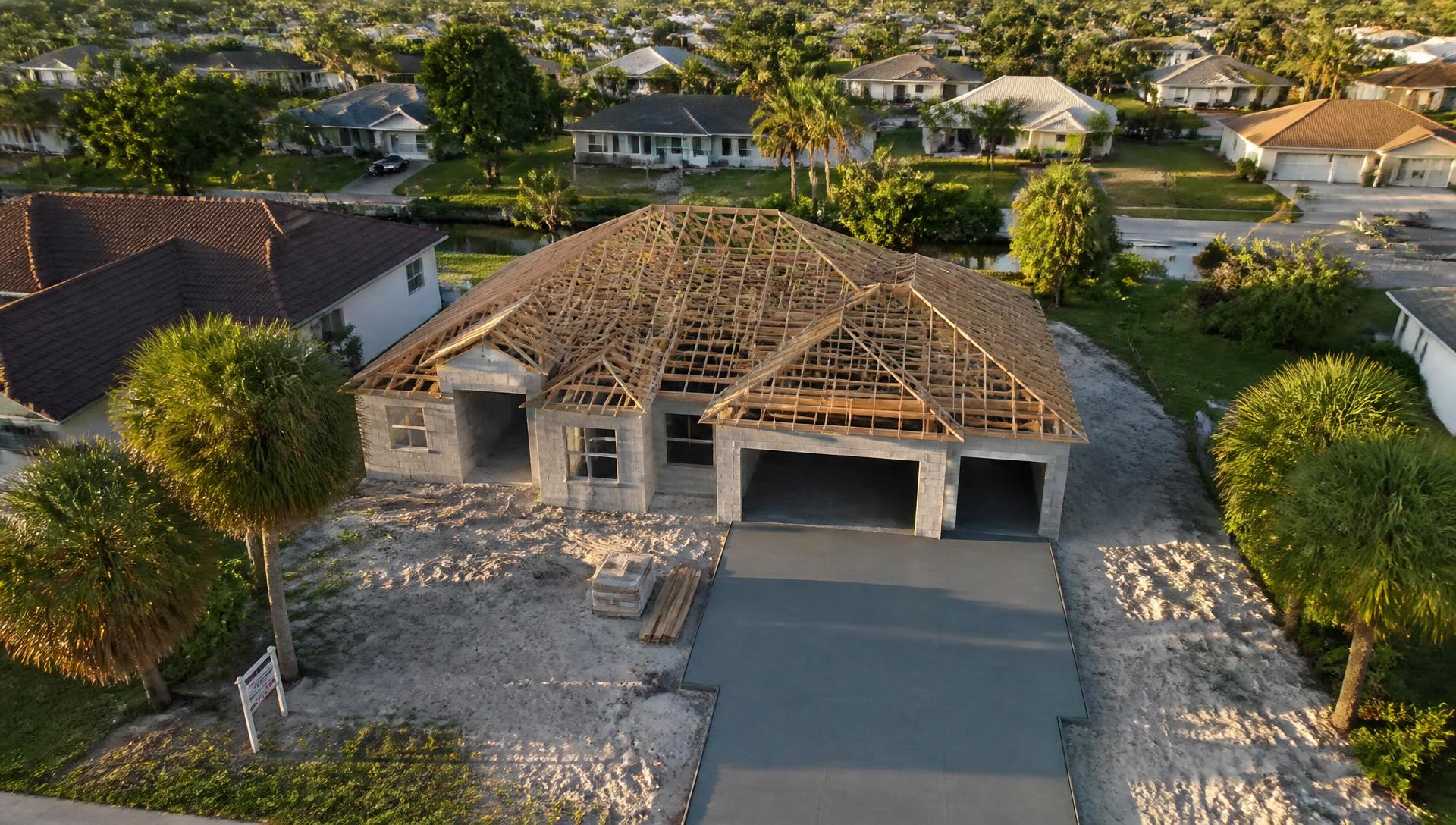 Aerial drone view of a Florida home under construction with roof trusses set